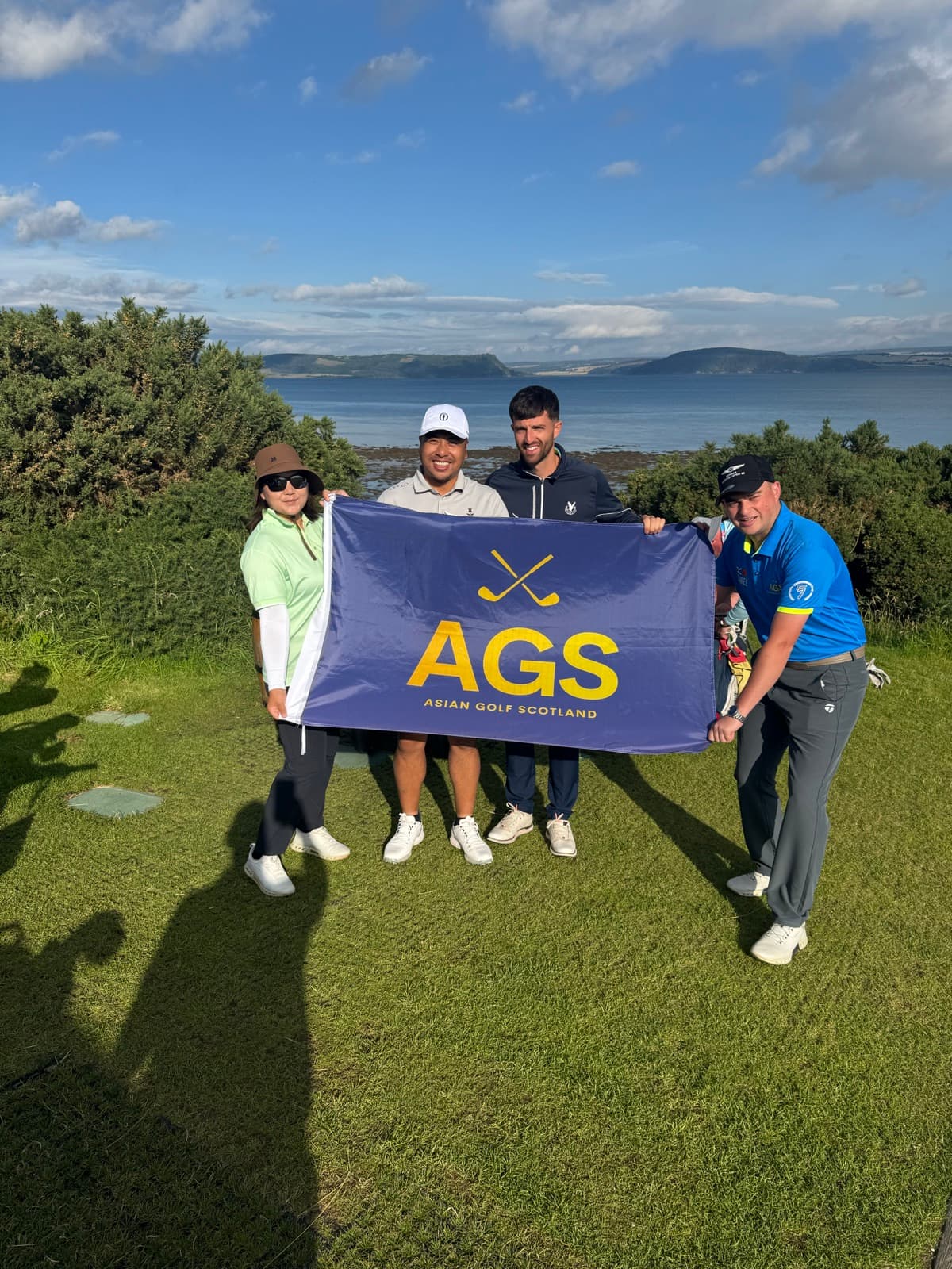 AGS guests with the flag on the Scottish coast
